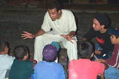 Teen volunteer sharing the gospel with kids in the open air