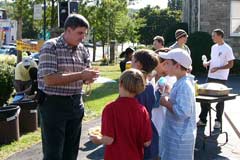 OAC evangelist speaking with children at a block party